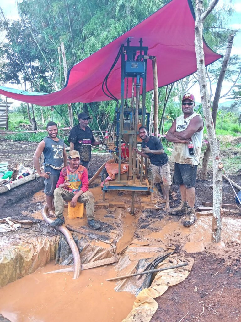 Drilling in progress with a red tarpaulin over the rig