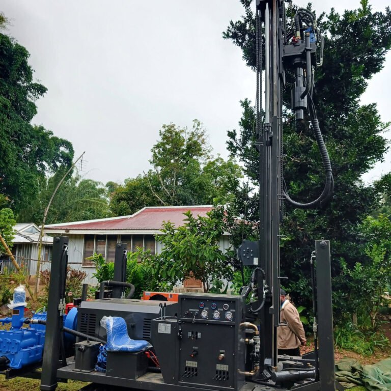 Drilling rig working in a village